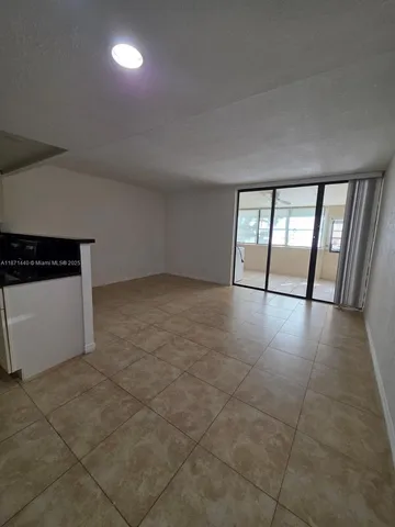 a bedroom with a bed and a refrigerator