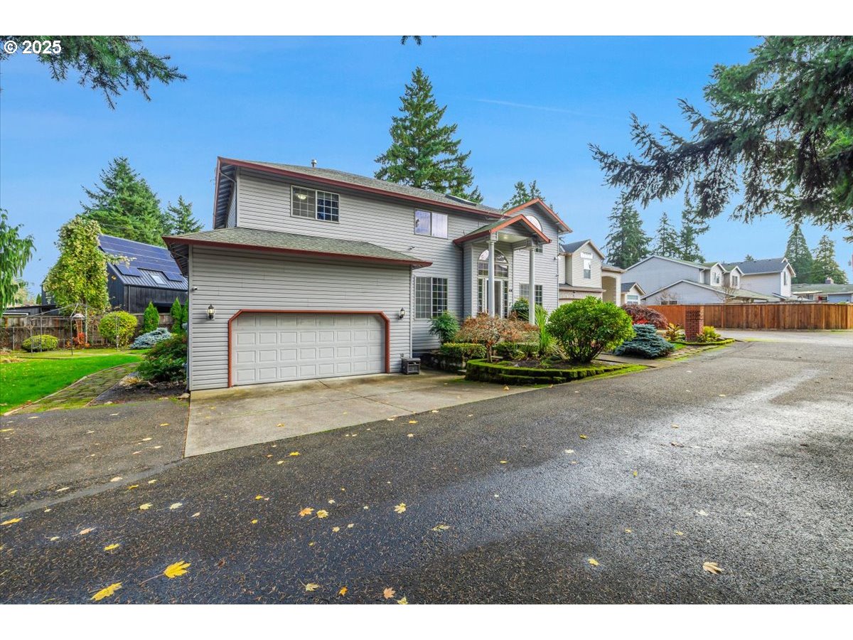 4738 Northeast 48th Place Portland, OR 97218 - Photo 40 of 42 a front view of a house with a yard and garage