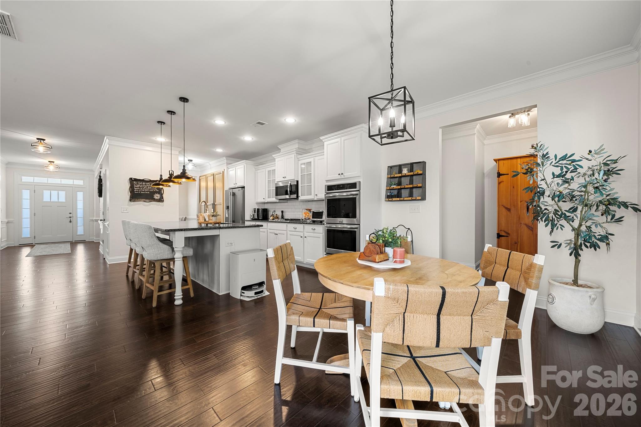 11266 Trailside Road Concord, NC 28027 - Photo 17 of 48 a dining room with stainless steel appliances kitchen island granite countertop a dining table chairs and chandelier