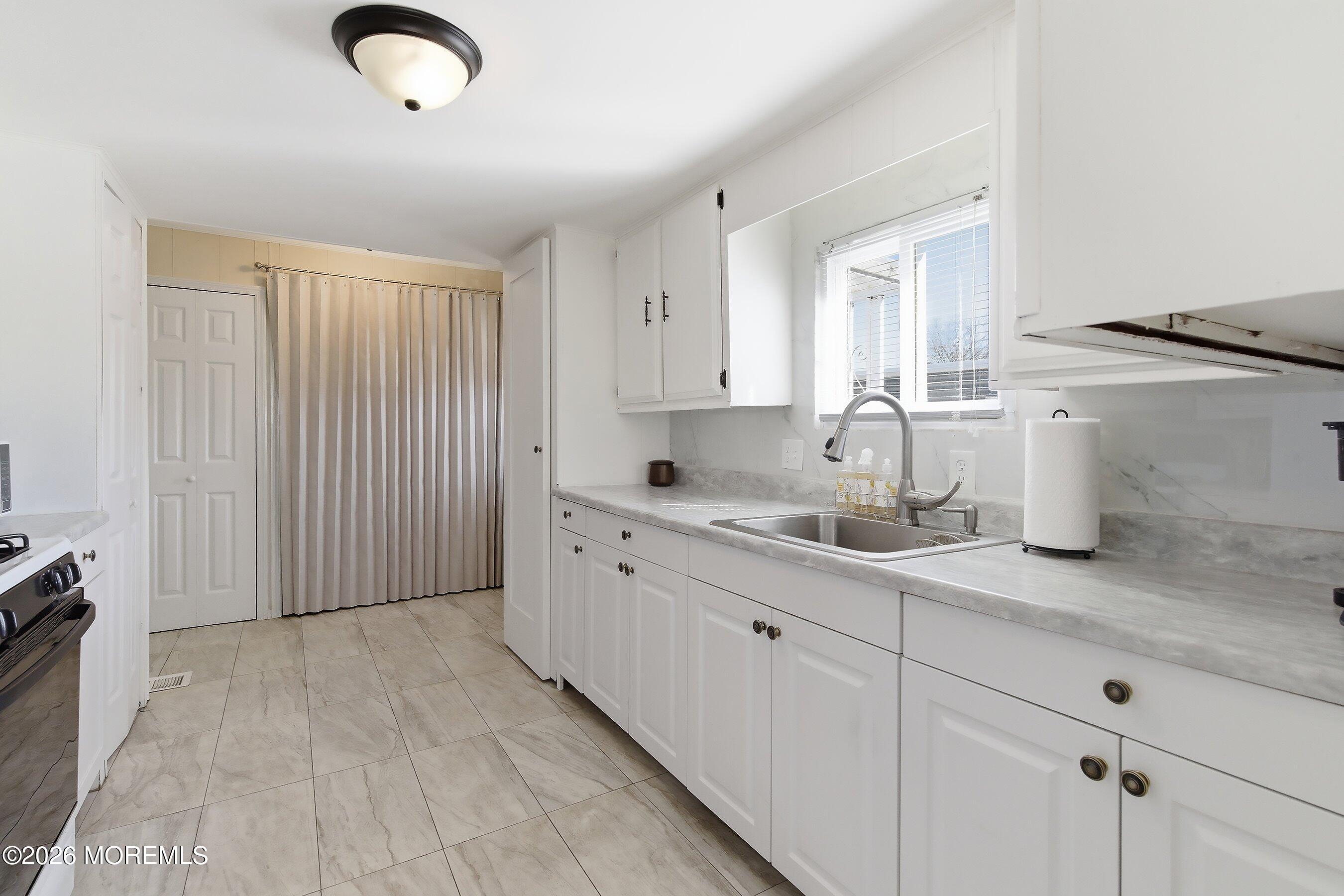 164 Camino Rio Toms River, NJ 08755 - Photo 12 of 36 a spacious bathroom with a granite countertop sink and a mirror