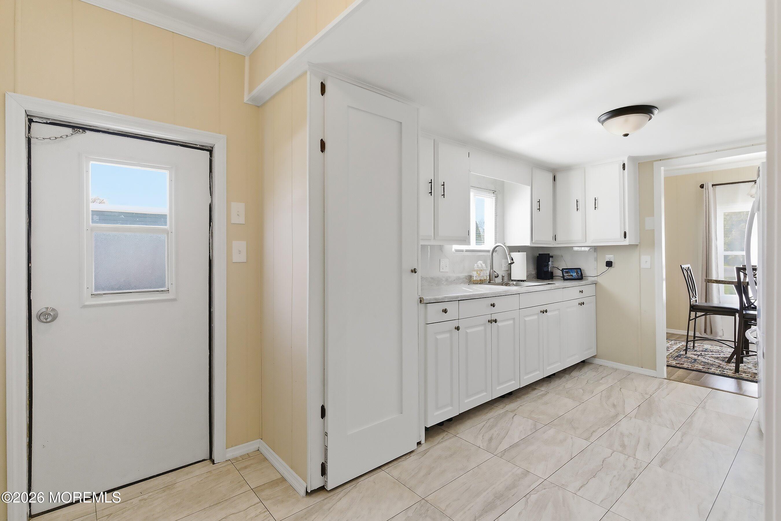 164 Camino Rio Toms River, NJ 08755 - Photo 15 of 36 a kitchen with white cabinets and white appliances