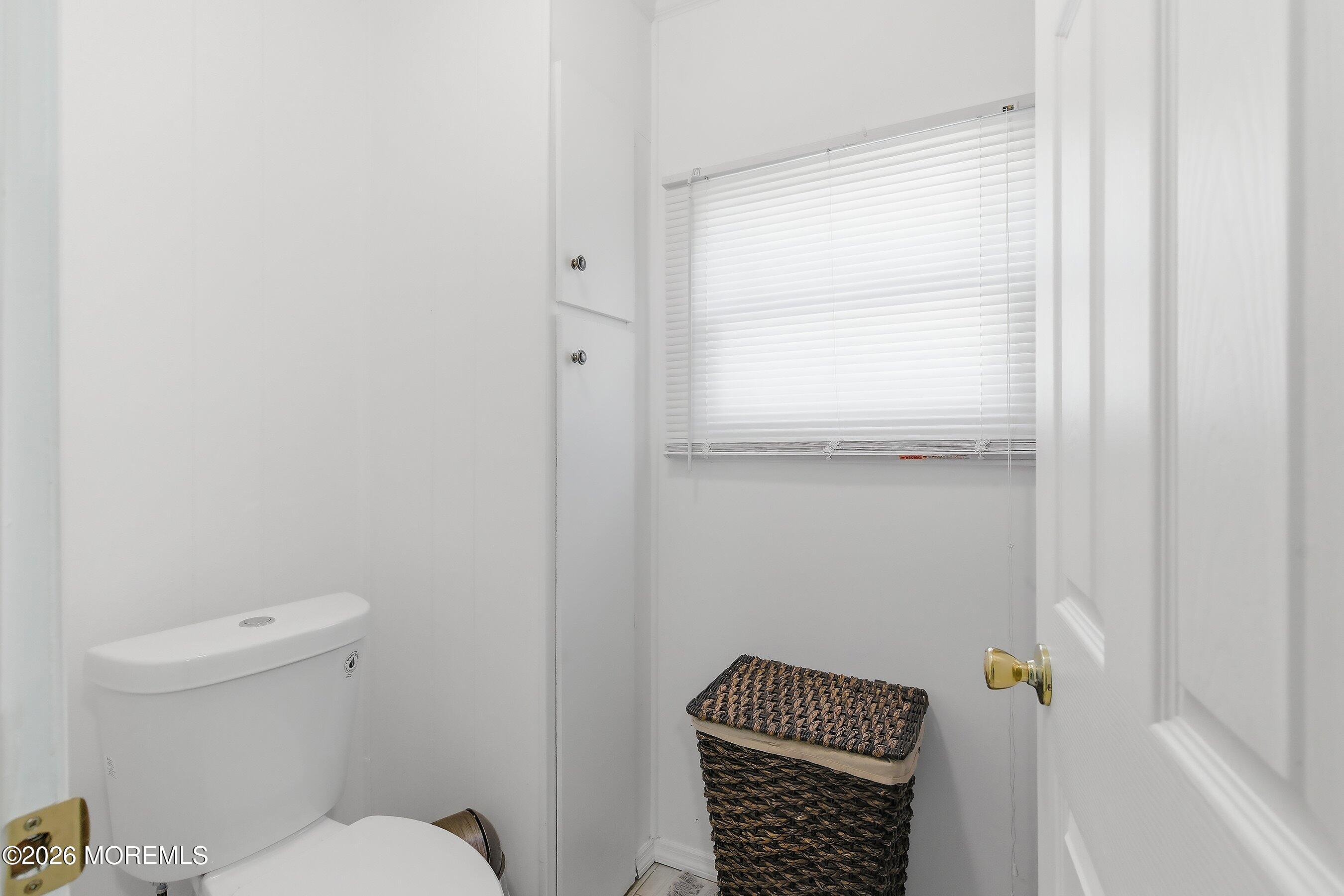164 Camino Rio Toms River, NJ 08755 - Photo 19 of 36 a bathroom with a toilet a sink and a window