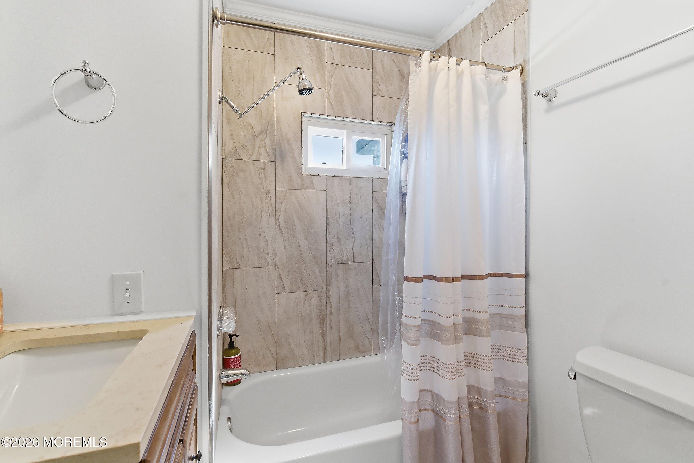 164 Camino Rio Toms River, NJ 08755 - Photo 23 of 36 a bathroom with a shower curtain and a bathtub