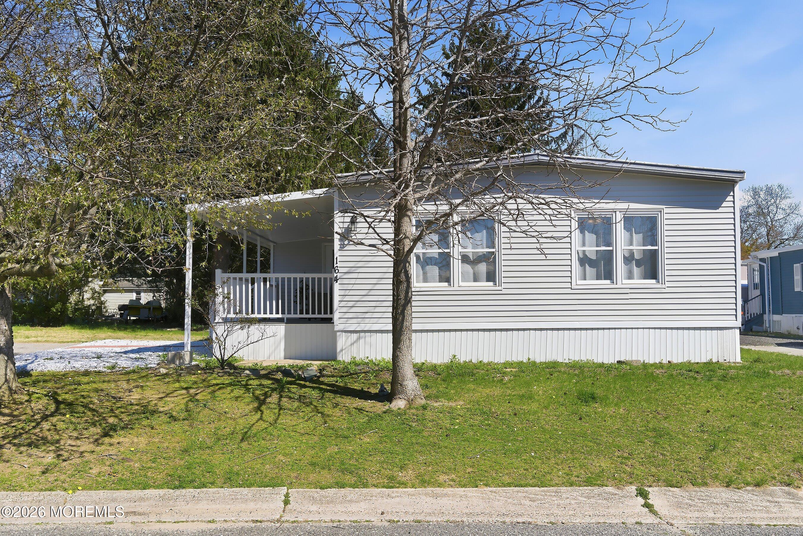 164 Camino Rio Toms River, NJ 08755 - Photo 3 of 36 a house that has a tree in front of it