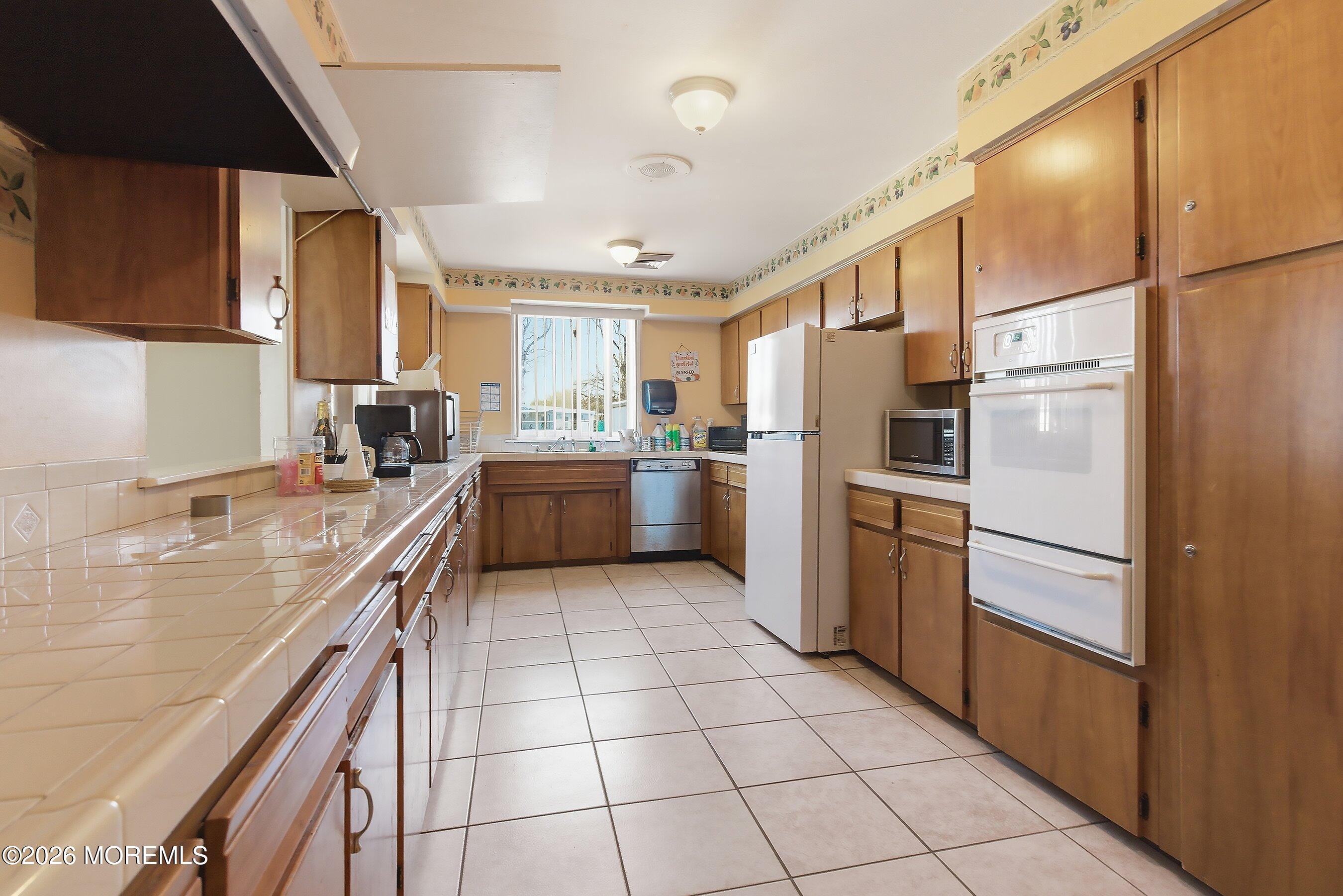 164 Camino Rio Toms River, NJ 08755 - Photo 36 of 36 a kitchen with a sink a counter top space stainless steel appliances and cabinets