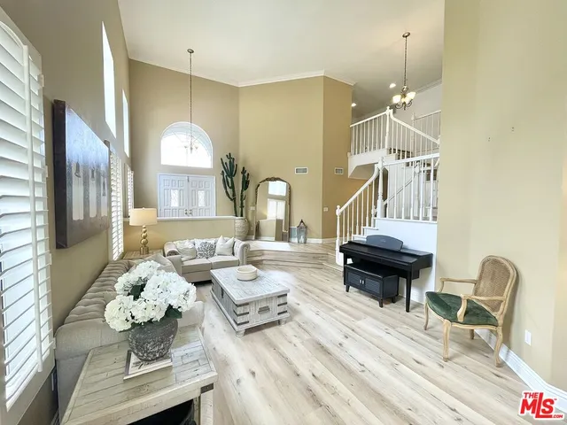 a living room with fireplace furniture and a chandelier