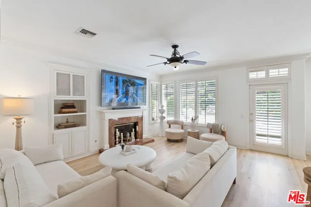 a living room with furniture fireplace and a large window