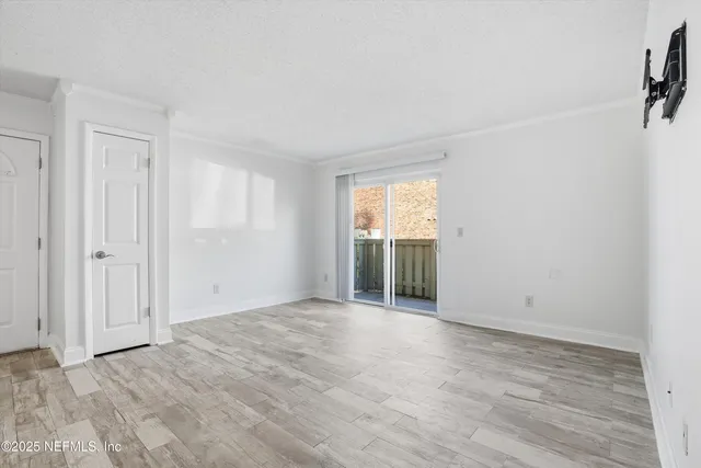 a view of an empty room with a window