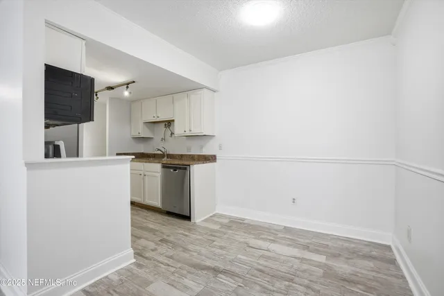 a kitchen with a refrigerator a stove top oven a sink and dishwasher