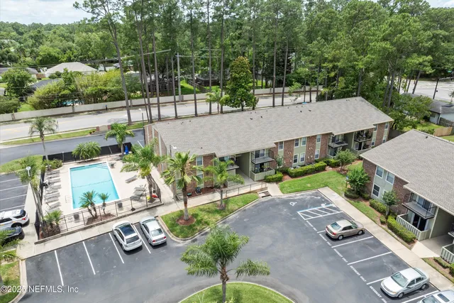 an aerial view of a house with a yard