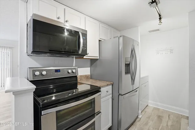 a kitchen with a stove and a microwave