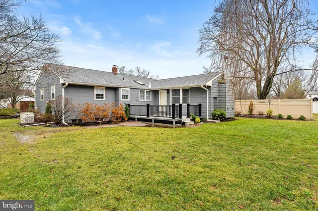 a front view of house with yard barbeque oven and seating