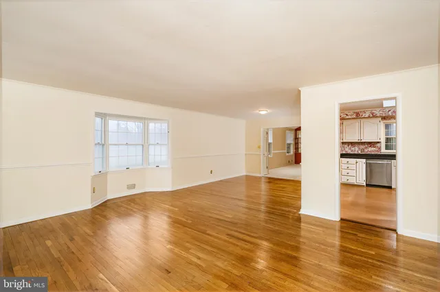 a view of a kitchen with wooden floor and a kitchen