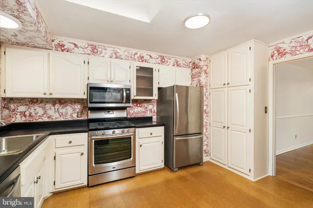 a kitchen with stainless steel appliances a refrigerator stove and microwave