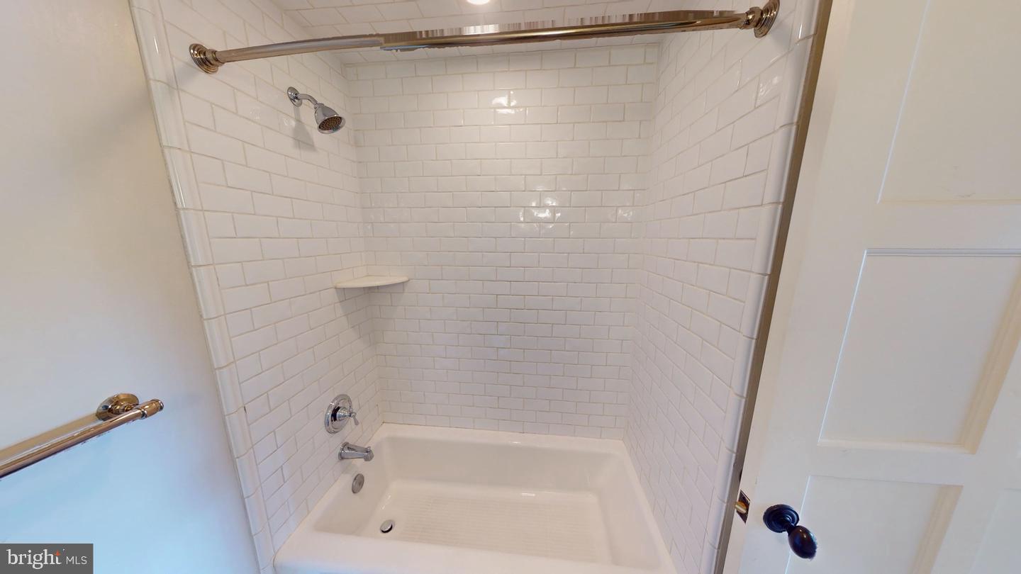 6 South Valley Road, Unit D Paoli, PA 19301 - Photo 3 of 7 a bathroom with a shower and a bath tub