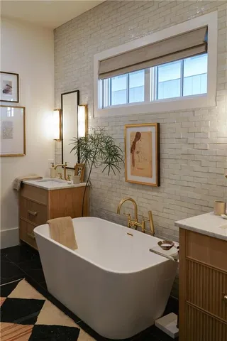 a bathroom with a sink a mirror and a bathtub