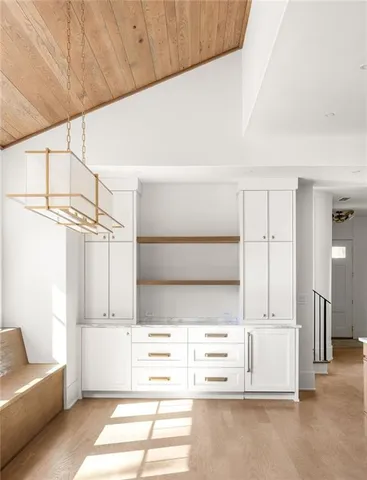 a view of kitchen with furniture and refrigerator