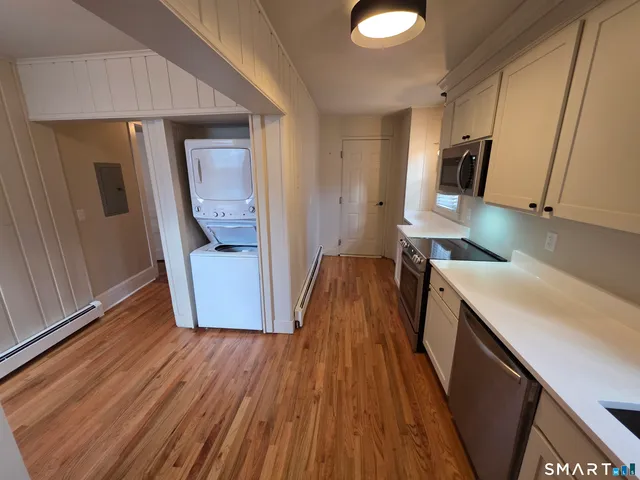 a view of a kitchen from a hallway