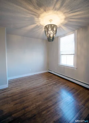 an empty room with wooden floor