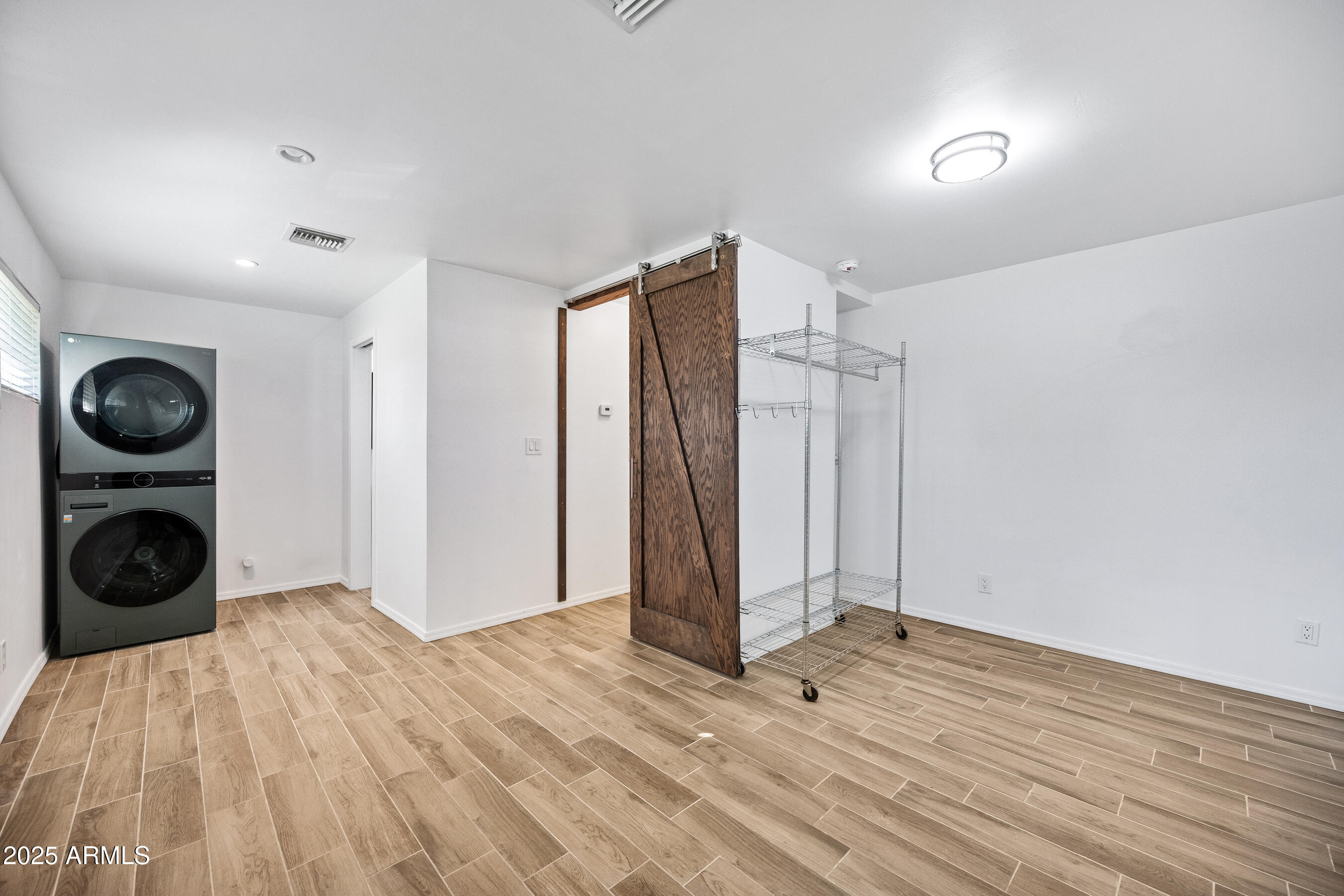 1014 East Orange Drive Phoenix, AZ 85014 - Photo 12 of 20 a view of empty room with wooden floor and fan