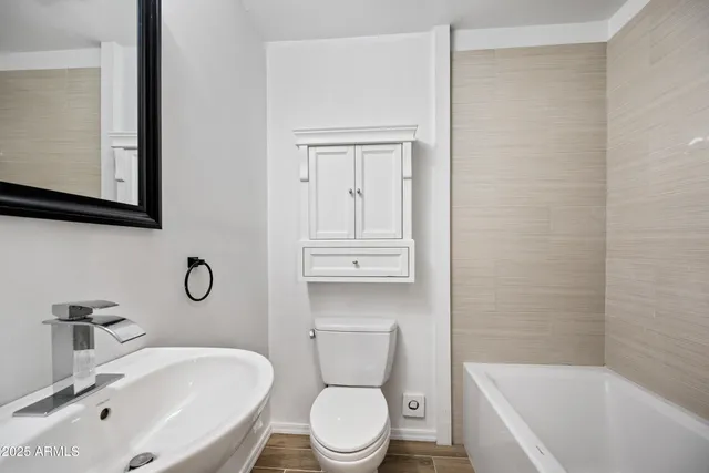 a bathroom with a sink a toilet and bathtub