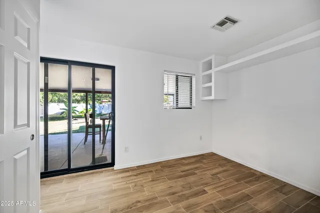 a view of an empty room with glass door