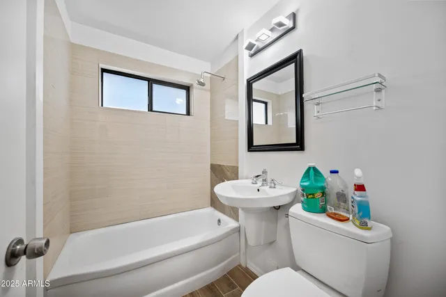 a white toilet sitting next to a bathroom sink