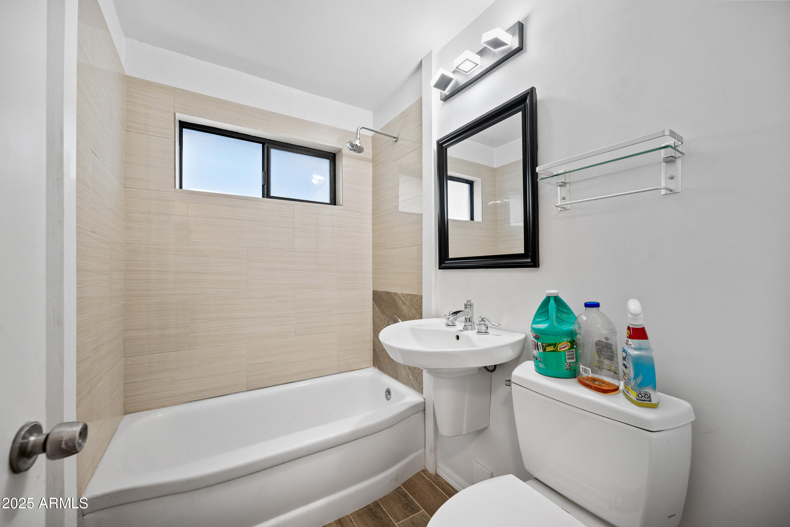 1014 East Orange Drive Phoenix, AZ 85014 - Photo 17 of 20 a white toilet sitting next to a bathroom sink