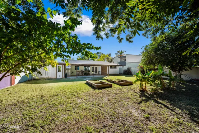 a view of a house with swimming pool and sitting area