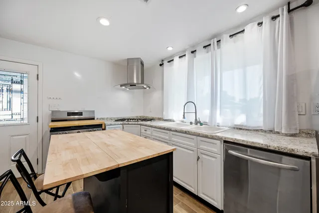a kitchen with appliances cabinets and a sink