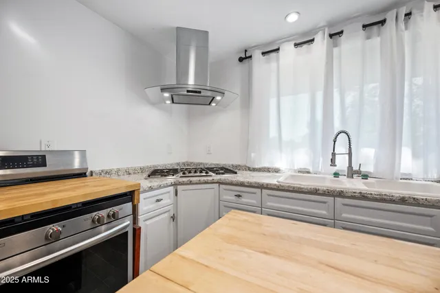 a kitchen with stainless steel appliances a sink and a stove