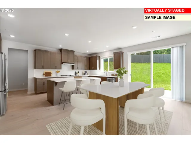 a living room with stainless steel appliances kitchen island granite countertop furniture and a large window