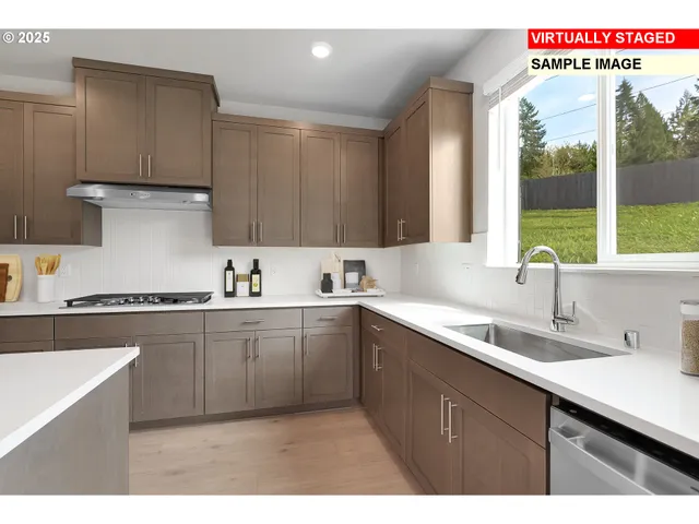 a kitchen with a sink cabinets and window