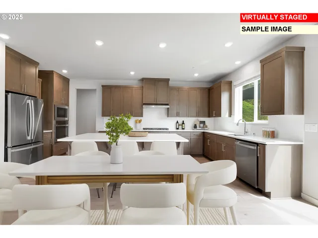 a kitchen with a table chairs refrigerator and microwave