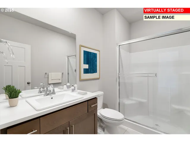 a bathroom with a sink a toilet a mirror and shower