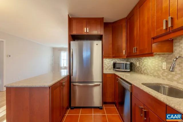 a kitchen with stainless steel appliances a refrigerator and a stove