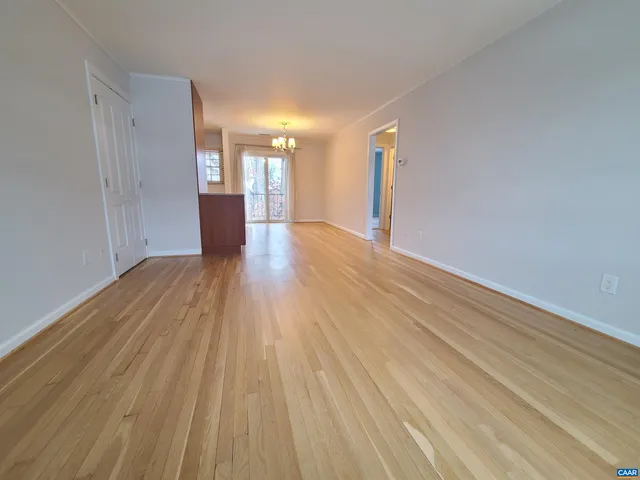 an empty room with a bathroom and mirror