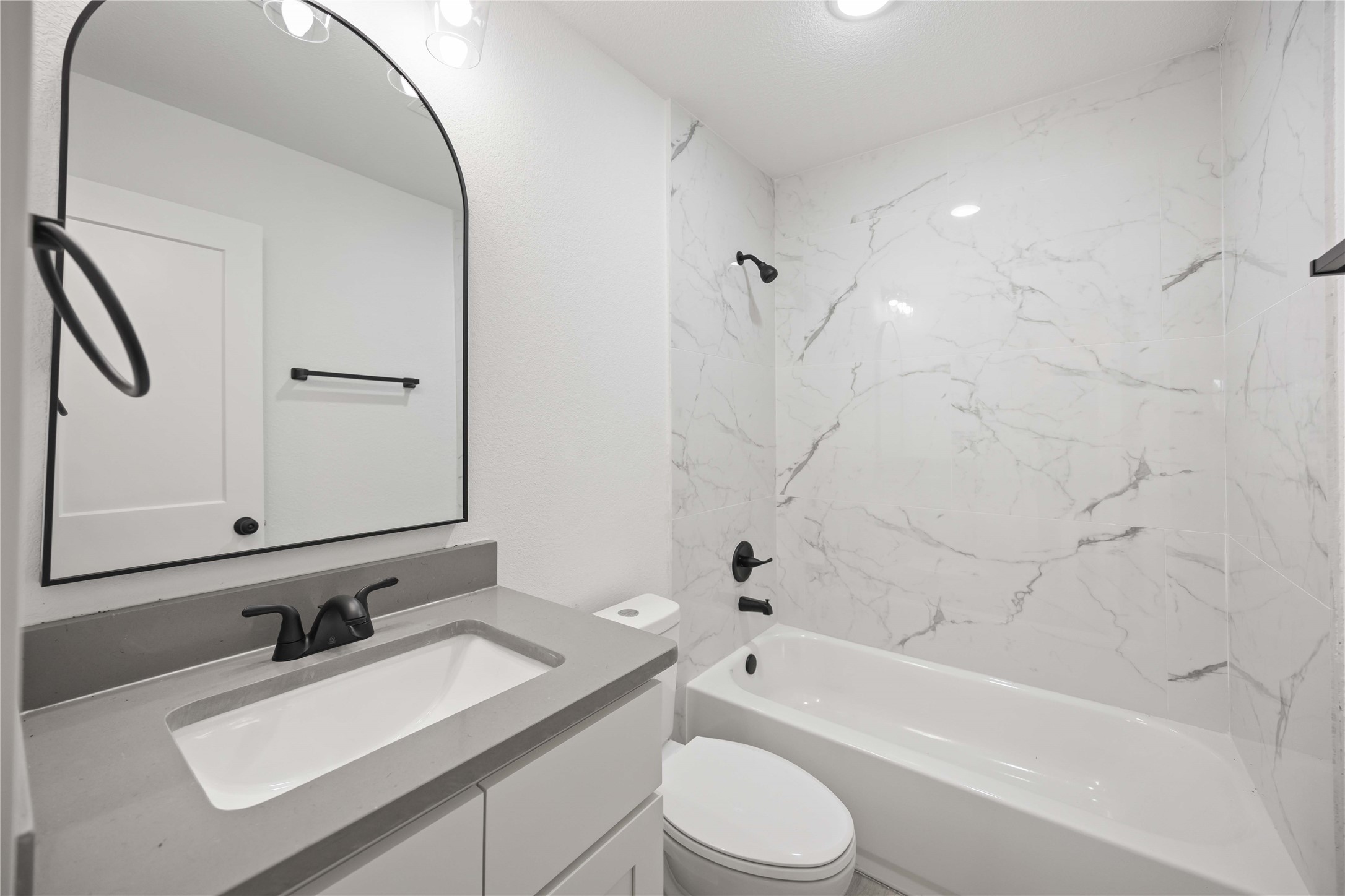 3405 Mt Pleasant Street Houston, TX 77021 - Photo 10 of 20 Elegant bathroom with modern fixtures and marble-inspired tiles.