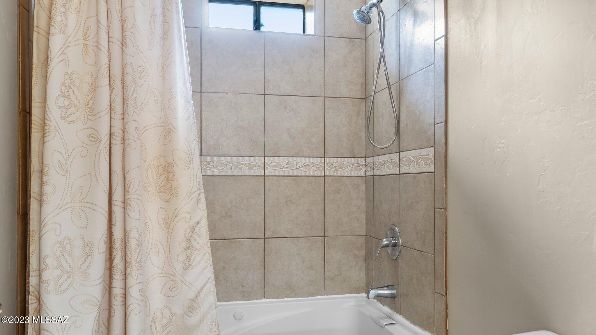 96 Calle Quintana Rio Rico, AZ 85648 - Photo 27 of 30 a bathroom with a glass shower door