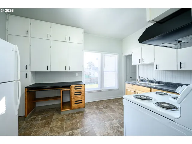 a kitchen that has a sink and a stove