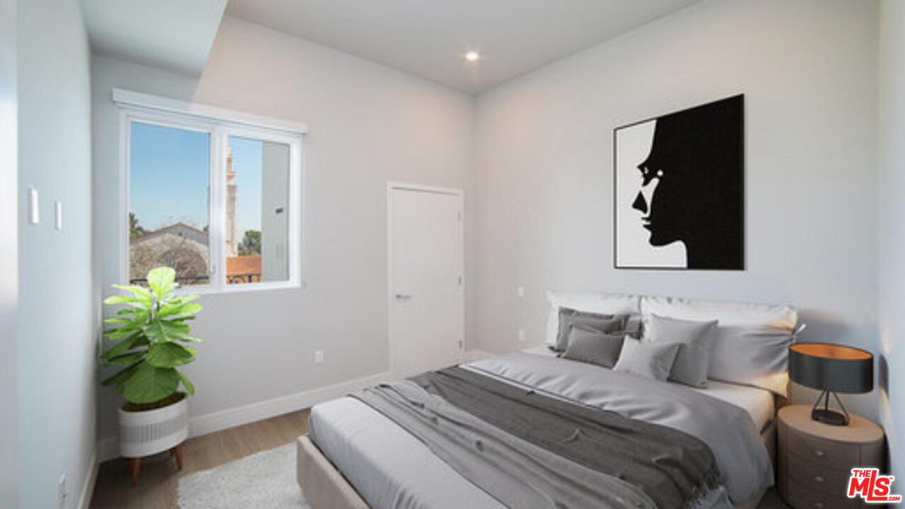 909 Le Doux Road, Unit 403 Los Angeles, CA 90035 - Photo 15 of 28 a bedroom with bed and a window