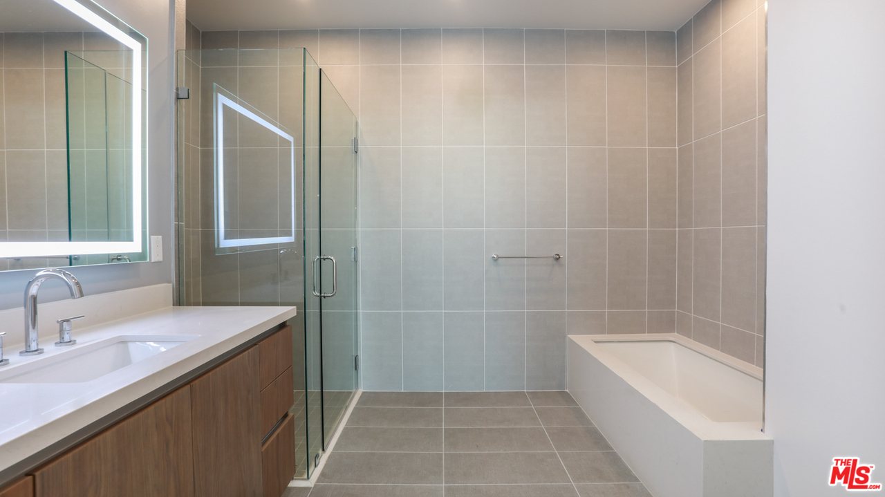 909 Le Doux Road, Unit 403 Los Angeles, CA 90035 - Photo 18 of 28 a bathroom with a sink a toilet and shower