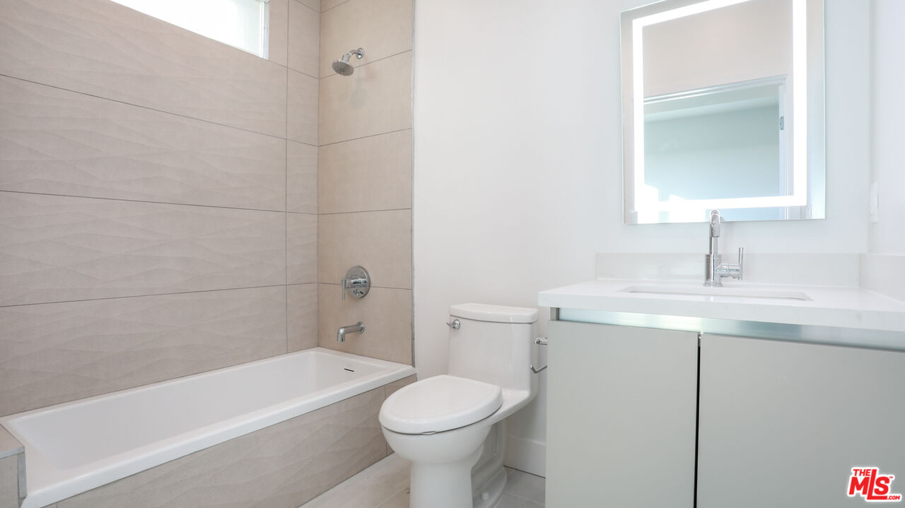 909 Le Doux Road, Unit 403 Los Angeles, CA 90035 - Photo 20 of 28 a bathroom with a sink a toilet and shower