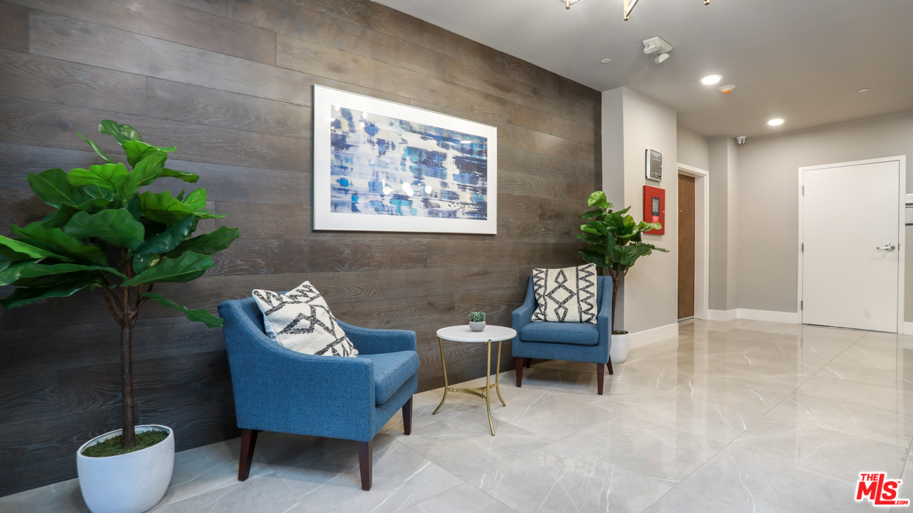 909 Le Doux Road, Unit 403 Los Angeles, CA 90035 - Photo 26 of 28 a living room with furniture and flowers