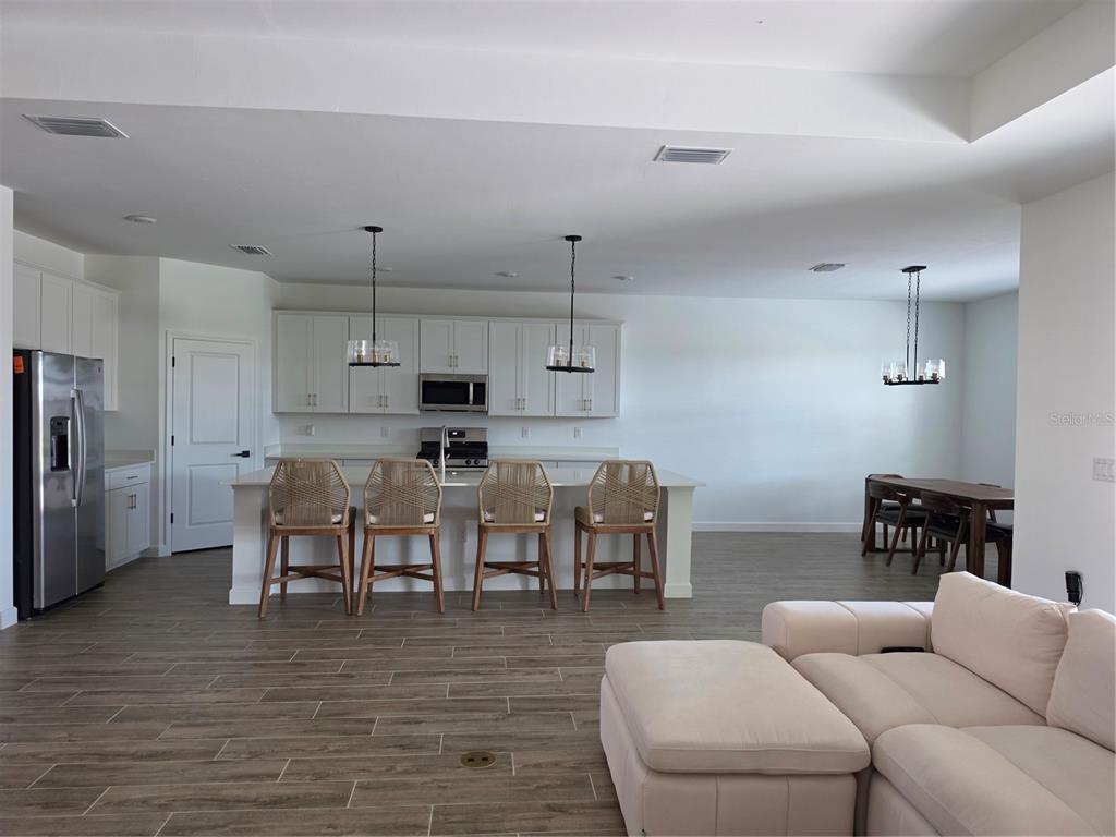 18334 Ridgeline Drive Estero, FL 33928 - Photo 8 of 30 a living room with stainless steel appliances furniture and a kitchen view