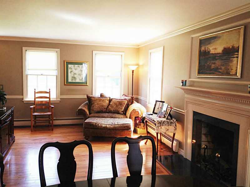Living Room. Fireplaced Living Room with Marble threshold and hardwoods!