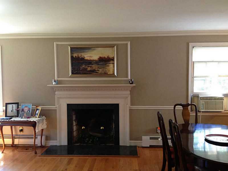 16 Sundale Road Cranston, RI 02921 - Photo 9 of 10 Living Room. Wood detailed fireplace mantle with marble dividing living and dining rooms!