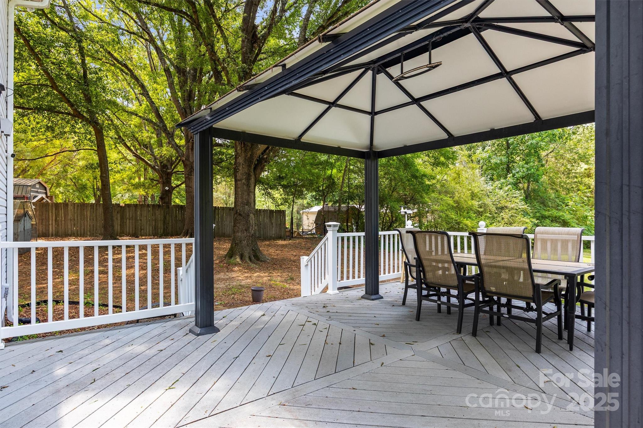 1975 Kehl Road Clover, SC 29710 - Photo 3 of 28 a patio with wooden floor a yard a table and chairs