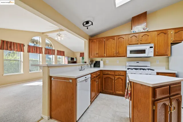 a kitchen that has a sink and a stove in it