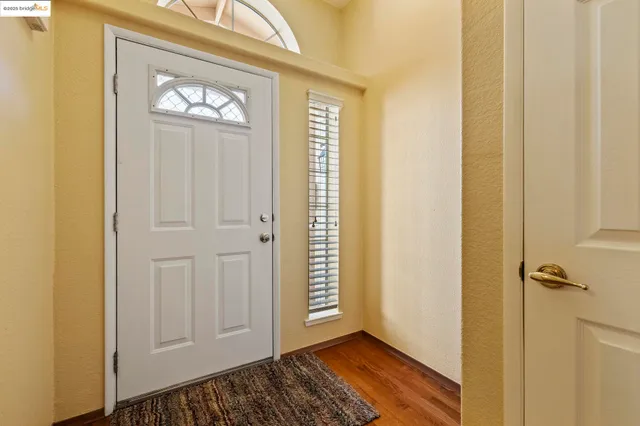 a view of a hallway with wooden floor and closet